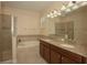 Bathroom features soaking tub, glass shower, double sinks, and granite countertops with bright lighting at 1569 Thetford Cir, Orlando, FL 32824
