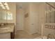 Well-lit bathroom featuring tile flooring, double sinks, soaking tub, and a separate glass shower at 1569 Thetford Cir, Orlando, FL 32824