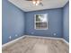 Cozy bedroom with hardwood floors, a ceiling fan, and a window letting in natural light at 1569 Thetford Cir, Orlando, FL 32824