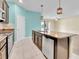 Kitchen with stainless steel appliances, dark wood cabinets, granite countertops, and a view to the living room at 1569 Thetford Cir, Orlando, FL 32824