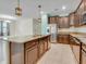 Open-concept kitchen featuring an island with a sink and stainless-steel appliances, perfect for entertaining at 1569 Thetford Cir, Orlando, FL 32824