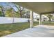 Covered patio overlooking the backyard with green grass and a white privacy fence at 3824 Deer Ridge Dr, Mount Dora, FL 32757