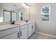 Bathroom featuring dual sinks, a long vanity, and a separate glass-enclosed shower at 3824 Deer Ridge Dr, Mount Dora, FL 32757