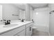 Bright bathroom featuring dual sinks, white cabinets, and a shower-tub combination at 3824 Deer Ridge Dr, Mount Dora, FL 32757