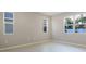 Bright, empty bedroom with neutral walls, white trim, and tile flooring at 3824 Deer Ridge Dr, Mount Dora, FL 32757