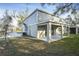 View of the house exterior showcasing a covered patio and a spacious backyard at 3824 Deer Ridge Dr, Mount Dora, FL 32757