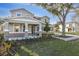 Charming two-story home featuring stone accents, a covered porch, and beautifully landscaped front yard at 3824 Deer Ridge Dr, Mount Dora, FL 32757