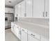 Bright kitchen featuring white cabinets, stainless steel appliances, and elegant quartz countertops at 3824 Deer Ridge Dr, Mount Dora, FL 32757