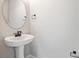 This powder room features a pedestal sink, stylish mirror, and modern fixtures at 3824 Deer Ridge Dr, Mount Dora, FL 32757