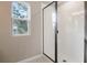 Modern shower with glass enclosure, white subway tile, and natural light from a window at 3824 Deer Ridge Dr, Mount Dora, FL 32757