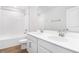 Bathroom with white cabinets, double vanity, and a bathtub at 520 Summit River Dr, Apopka, FL 32712