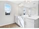 Modern bathroom boasts double vanity, white cabinets, and stylish tile flooring at 520 Summit River Dr, Apopka, FL 32712