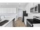 Modern kitchen with white cabinets and stainless steel appliances at 520 Summit River Dr, Apopka, FL 32712