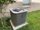 Carrier brand air conditioning unit beside exterior wall with grass at 14716 Yorkshire Run Dr, Orlando, FL 32828