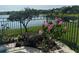 Landscaped backyard with flowers and trees overlooking community lake at 14716 Yorkshire Run Dr, Orlando, FL 32828