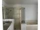 Bathroom with a glass door shower and separate bathtub with marble counters at 14716 Yorkshire Run Dr, Orlando, FL 32828
