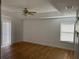 Bedroom featuring light hardwood floors, bright walls, a ceiling fan, and a window at 14716 Yorkshire Run Dr, Orlando, FL 32828
