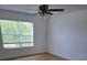 This bedroom features a ceiling fan, window with blinds, and wood-look flooring at 14716 Yorkshire Run Dr, Orlando, FL 32828