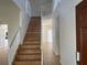 Bright foyer with wooden staircase, tile flooring, and access to multiple rooms at 14716 Yorkshire Run Dr, Orlando, FL 32828
