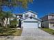 Charming two-story home featuring a well-manicured lawn, gray brick driveway and attached two-car garage at 14716 Yorkshire Run Dr, Orlando, FL 32828