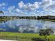 Beautiful lake view reflecting the clouds and blue sky of the community at 14716 Yorkshire Run Dr, Orlando, FL 32828