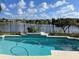 Pool with water overlooks backyard, flower garden, and the community lake at 14716 Yorkshire Run Dr, Orlando, FL 32828