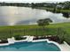 Enjoy this backyard pool with a beautiful lake view and black aluminum fence at 14716 Yorkshire Run Dr, Orlando, FL 32828