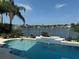 Relax in this pool overlooking a lake with a black aluminum fence at 14716 Yorkshire Run Dr, Orlando, FL 32828