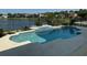 Beautiful pool with clear water and tile accents overlooks the backyard and lake at 14716 Yorkshire Run Dr, Orlando, FL 32828