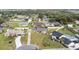 Expansive aerial view showcasing the neighborhood, well-manicured lawns, and mature trees at 1855 Cavalier Ct, Kissimmee, FL 34744
