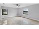 Serene bedroom featuring large windows, a ceiling fan, and ample natural light at 1855 Cavalier Ct, Kissimmee, FL 34744