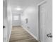 Hallway with gray wood-look flooring and white walls at 1855 Cavalier Ct, Kissimmee, FL 34744
