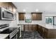 Modern kitchen featuring stainless steel appliances, sleek countertops, and stylish backsplash at 1855 Cavalier Ct, Kissimmee, FL 34744