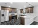 Modern kitchen featuring stainless steel appliances, updated cabinetry, and a breakfast bar with granite countertops at 1855 Cavalier Ct, Kissimmee, FL 34744