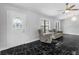 Bright living room featuring updated flooring, large windows, and a statement chandelier at 1855 Cavalier Ct, Kissimmee, FL 34744