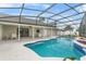 Screened pool with tiled trim and a covered patio at 1855 Cavalier Ct, Kissimmee, FL 34744