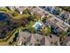 Aerial view of community featuring a pool, pond, parking, landscaping and colorful buildings at 3151 Britannia Blvd # C, Kissimmee, FL 34747