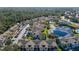Aerial view of a colorful community with a pool, pond, parking, and lush landscaping in a desirable location at 3151 Britannia Blvd # C, Kissimmee, FL 34747