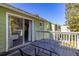 Outdoor balcony with metal table and seating area, offering a view to trees and a glimpse of the interior at 3151 Britannia Blvd # C, Kissimmee, FL 34747