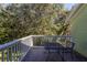 Relaxing outdoor balcony showing a metal table and chairs and a view to a lush green lawn at 3151 Britannia Blvd # C, Kissimmee, FL 34747