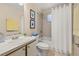 Bright bathroom with a white shower curtain, neutral tile, and a white vanity at 3151 Britannia Blvd # C, Kissimmee, FL 34747