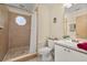 Bathroom featuring a tiled shower, decorative mirror and ample counter space at 3151 Britannia Blvd # C, Kissimmee, FL 34747