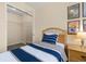 Cozy bedroom with a twin bed, mirrored closet, and beige walls at 3151 Britannia Blvd # C, Kissimmee, FL 34747
