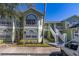 Inviting multi-story exterior with neat landscaping, white trim, and a wheelchair access sign at 3151 Britannia Blvd # C, Kissimmee, FL 34747