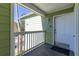 Cozy porch view with green siding, white railing, and the unit number displayed near the front door at 3151 Britannia Blvd # C, Kissimmee, FL 34747