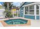 Inviting hot tub with blue tiling and a metal fence, adjacent to a building with large windows at 3151 Britannia Blvd # C, Kissimmee, FL 34747