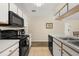 Functional kitchen with stainless steel appliances and tile flooring at 3151 Britannia Blvd # C, Kissimmee, FL 34747