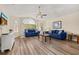 Spacious living room showcasing wood floors, a ceiling fan, and modern decor at 3151 Britannia Blvd # C, Kissimmee, FL 34747