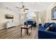 Bright living room featuring wood floors, two sofas, and a large window for ample natural light at 3151 Britannia Blvd # C, Kissimmee, FL 34747