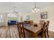 Open floor plan with living and dining areas featuring modern decor, wood floors, and ample natural light at 3151 Britannia Blvd # C, Kissimmee, FL 34747